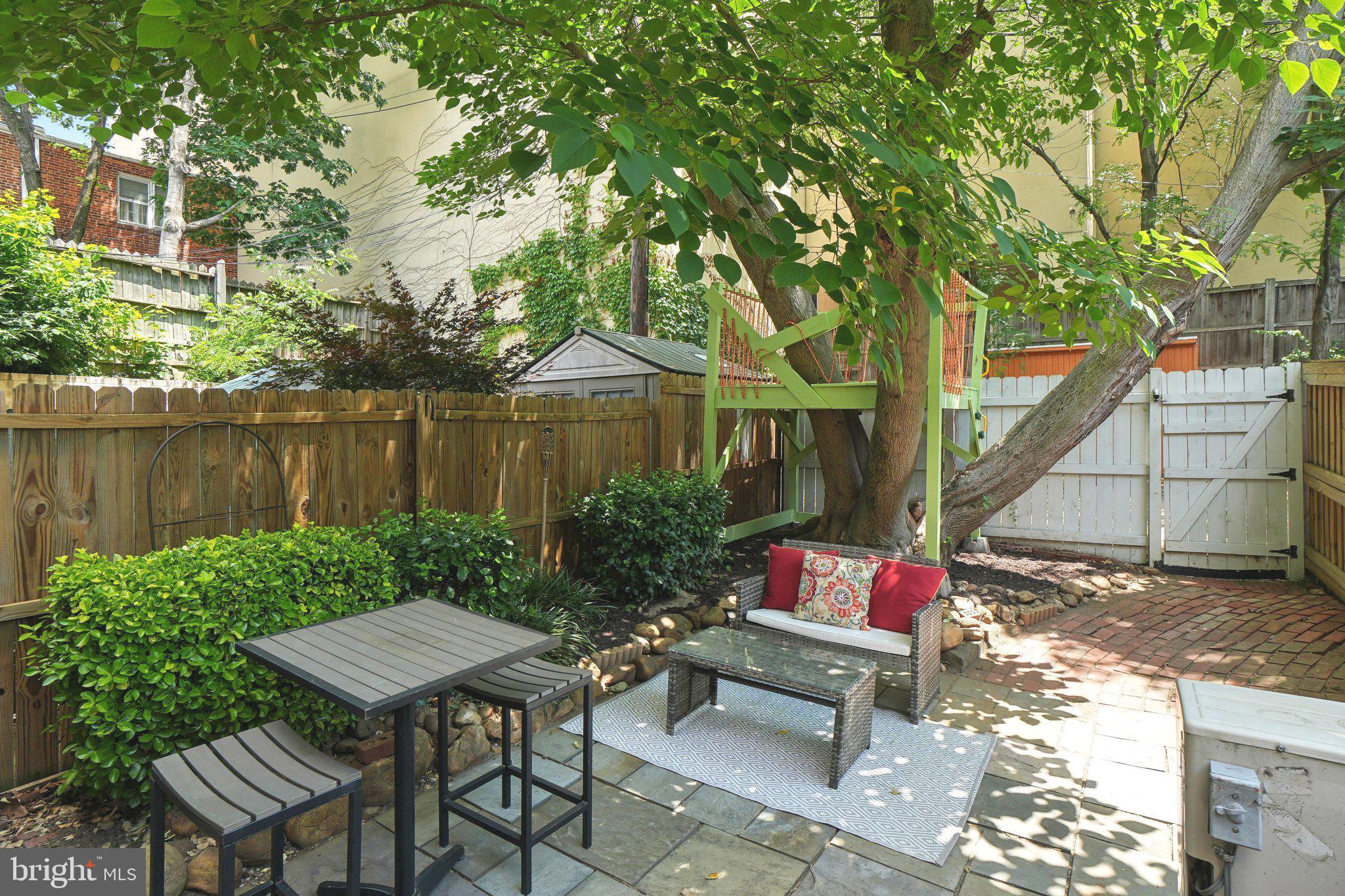 708 5th Street Southeast Washington, DC 20003 - Photo 9 of 25 a backyard of a house with table and chairs