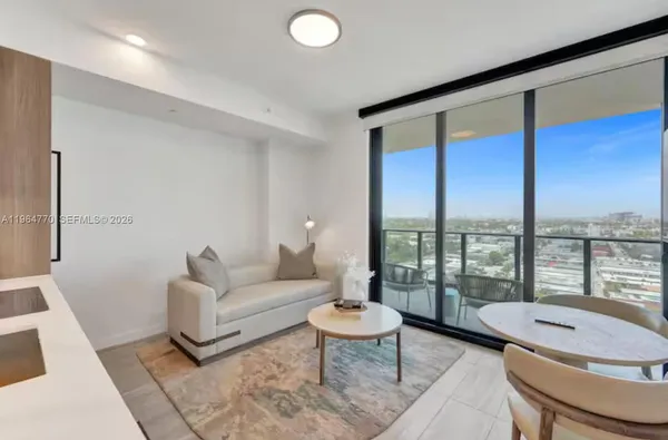 a living room with furniture and a large window