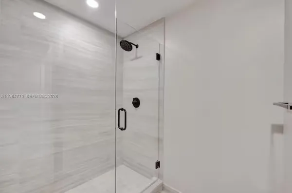a bathroom with a glass shower door