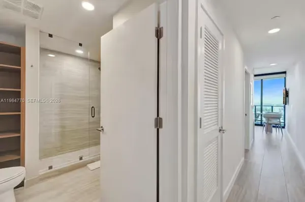 a close view of a utility room with dryer and washer