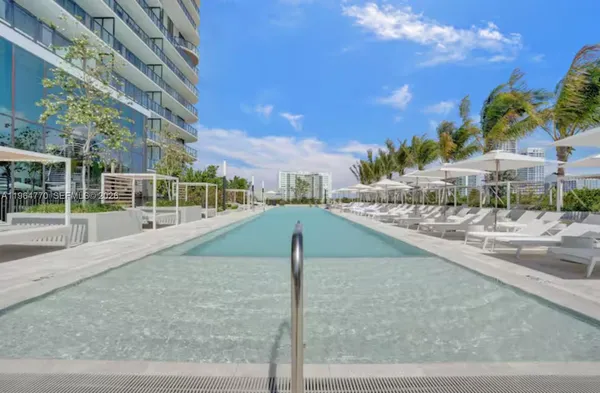 a patio with a table and chairs under an umbrella