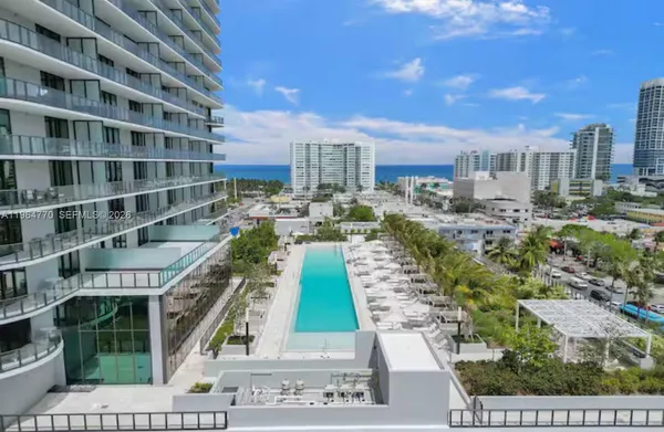 a view of a room with gym equipment and floor to ceiling window