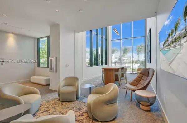 a kitchen with stainless steel appliances kitchen island granite countertop a refrigerator oven a sink and a dishwasher