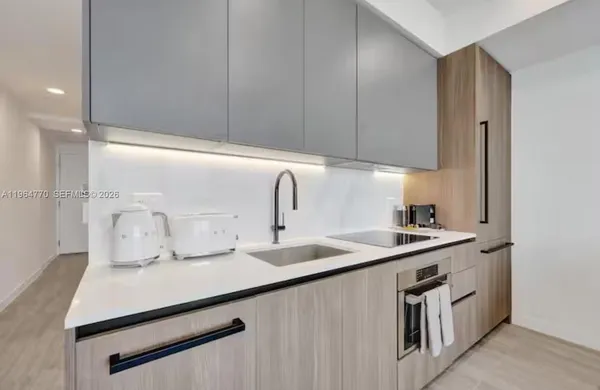 a kitchen with a sink cabinets and stainless steel appliances