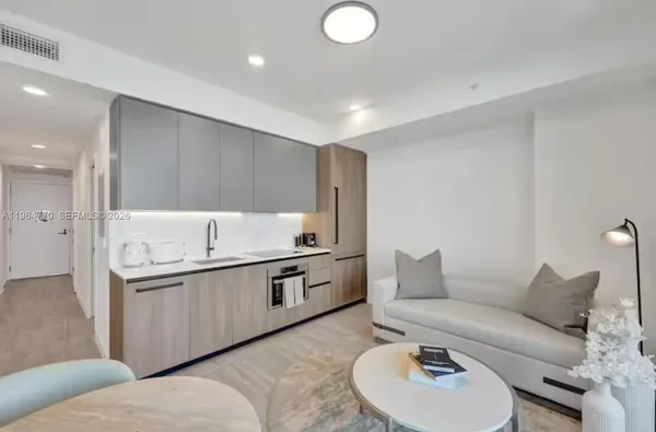 a living room with furniture and a sink