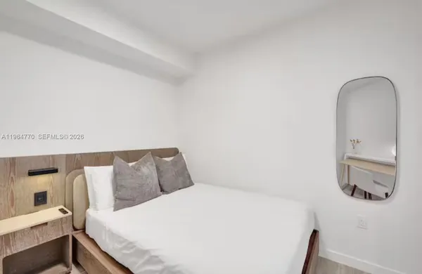 a bedroom with a bed and a couch