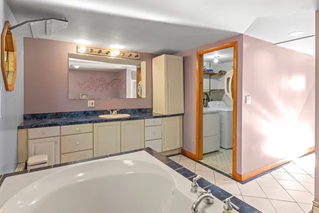 a spacious bathroom with a granite countertop sink and a mirror