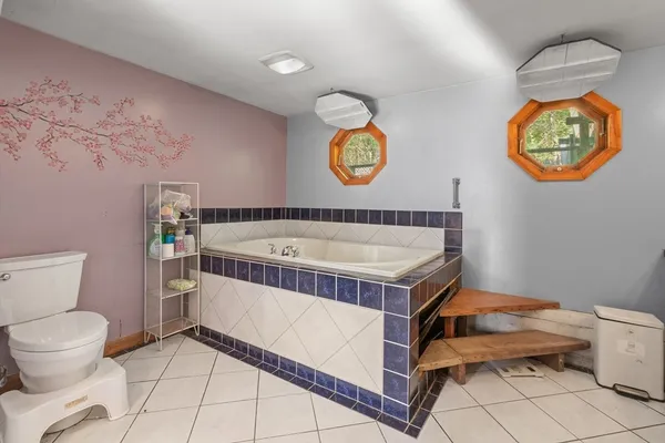 a bathroom with a sink a toilet and a window