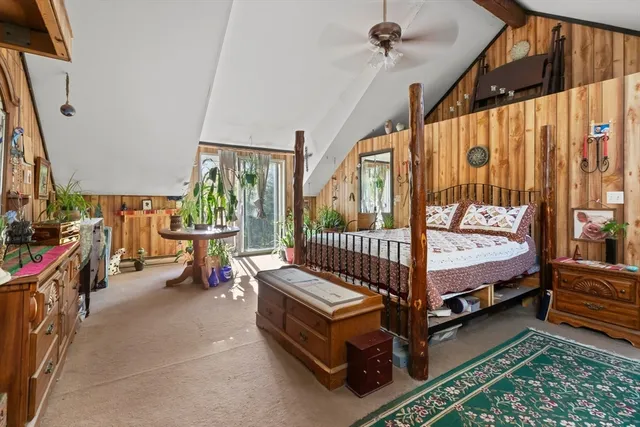 a bed sitting in a bedroom next to a window