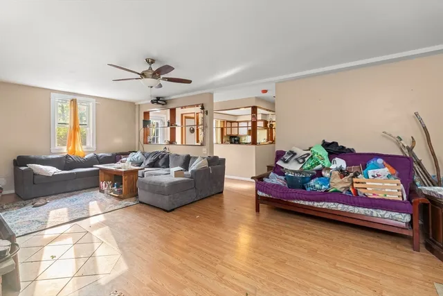 a living room with furniture gym equipment and a rug