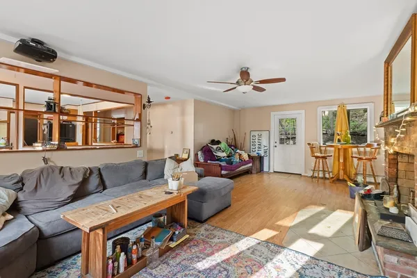 a kitchen with stainless steel appliances kitchen island granite countertop a table chairs and a refrigerator