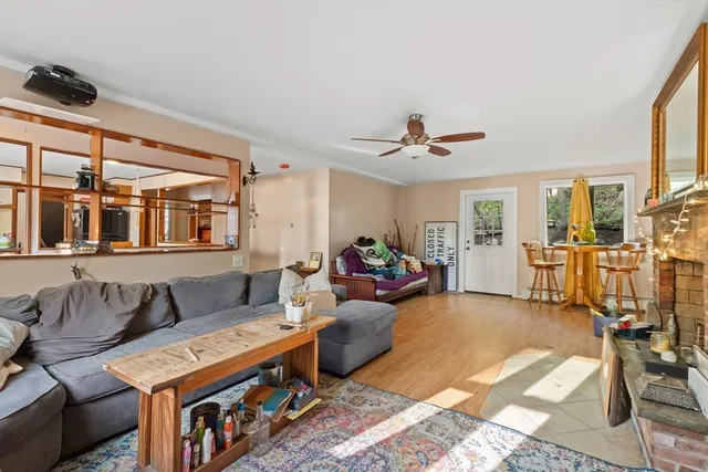 a kitchen with stainless steel appliances kitchen island granite countertop a table chairs and a refrigerator