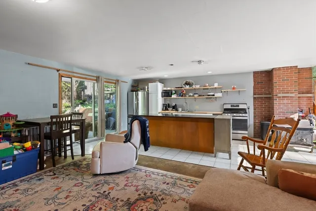 a living room with furniture a flat screen tv and a dining table