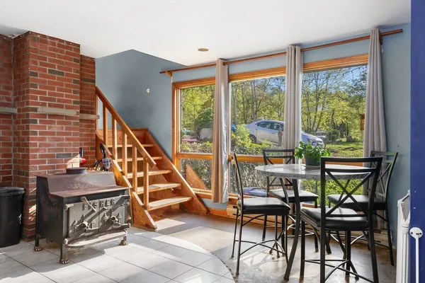 a dining room with furniture and stairs