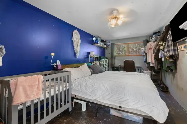 a bedroom with bed and a chandelier