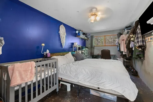a bedroom with bed and a chandelier
