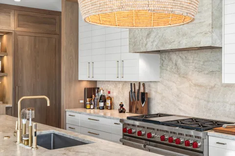 a kitchen with stainless steel appliances granite countertop a stove and a sink