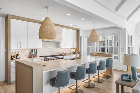 a kitchen with a table chairs stove and cabinets