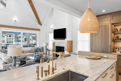 a kitchen with a sink a counter top space and a fireplace
