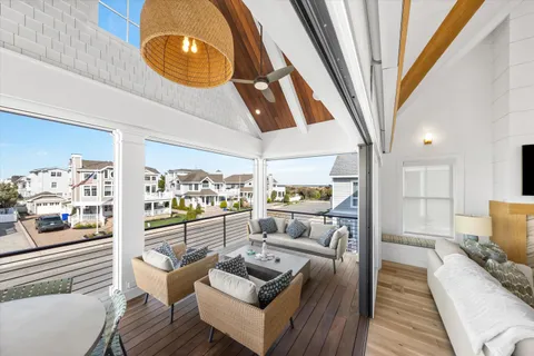 a living room with furniture and a floor to ceiling window
