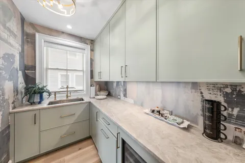 a kitchen with a sink cabinets and window