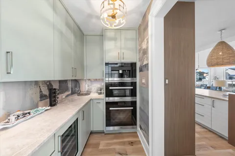 a kitchen with a sink stove and cabinets
