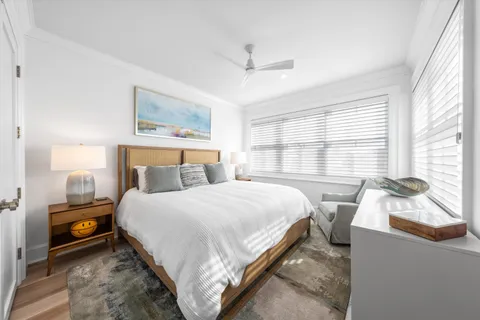 a bedroom with a bed and a large window