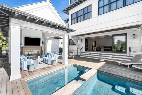 a living room with patio furniture and a fireplace