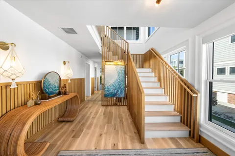 a view of a balcony with wooden floor and furniture