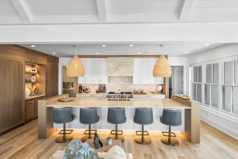 a kitchen with stainless steel appliances kitchen island granite countertop a sink and cabinets