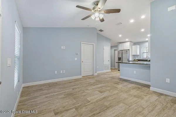 a view of a kitchen with a sink and a refrigerator