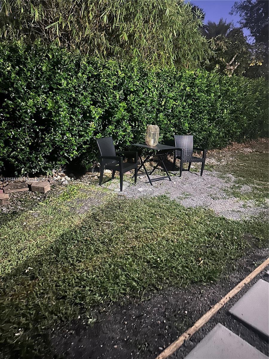 Eve Estates Homestead, FL 33033 - Photo 8 of 8 a view of a chair and table in the backyard