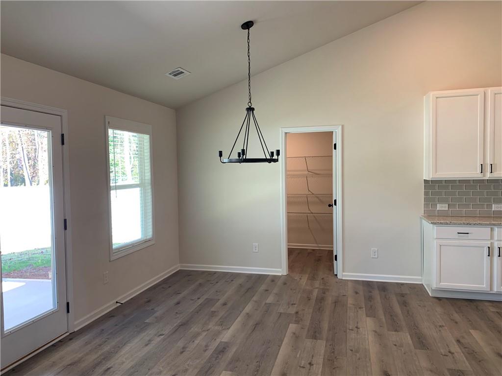 755 Rodeo Drive Auburn, GA 30011 - Photo 6 of 15 a view of empty room with wooden floor and window