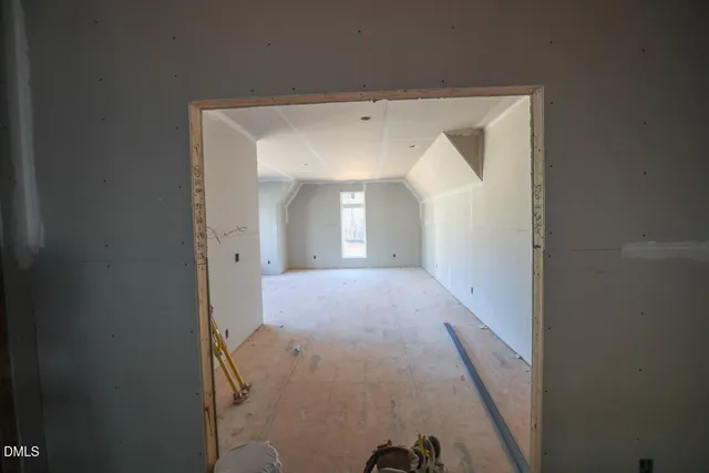a view of a hallway to a livingroom with furniture and wooden floor