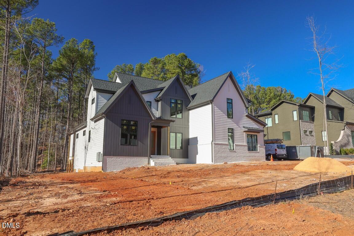 7429 Summer Tanager Trail Raleigh, NC 27614 - Photo 2 of 43 a view of a white house with a small yard and large trees