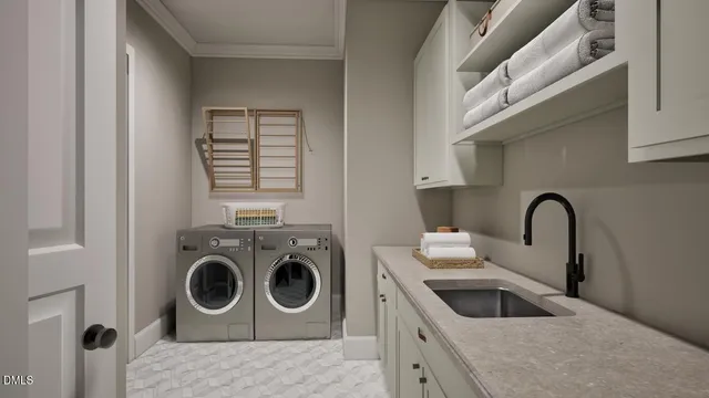 a utility room with sink dryer and washer