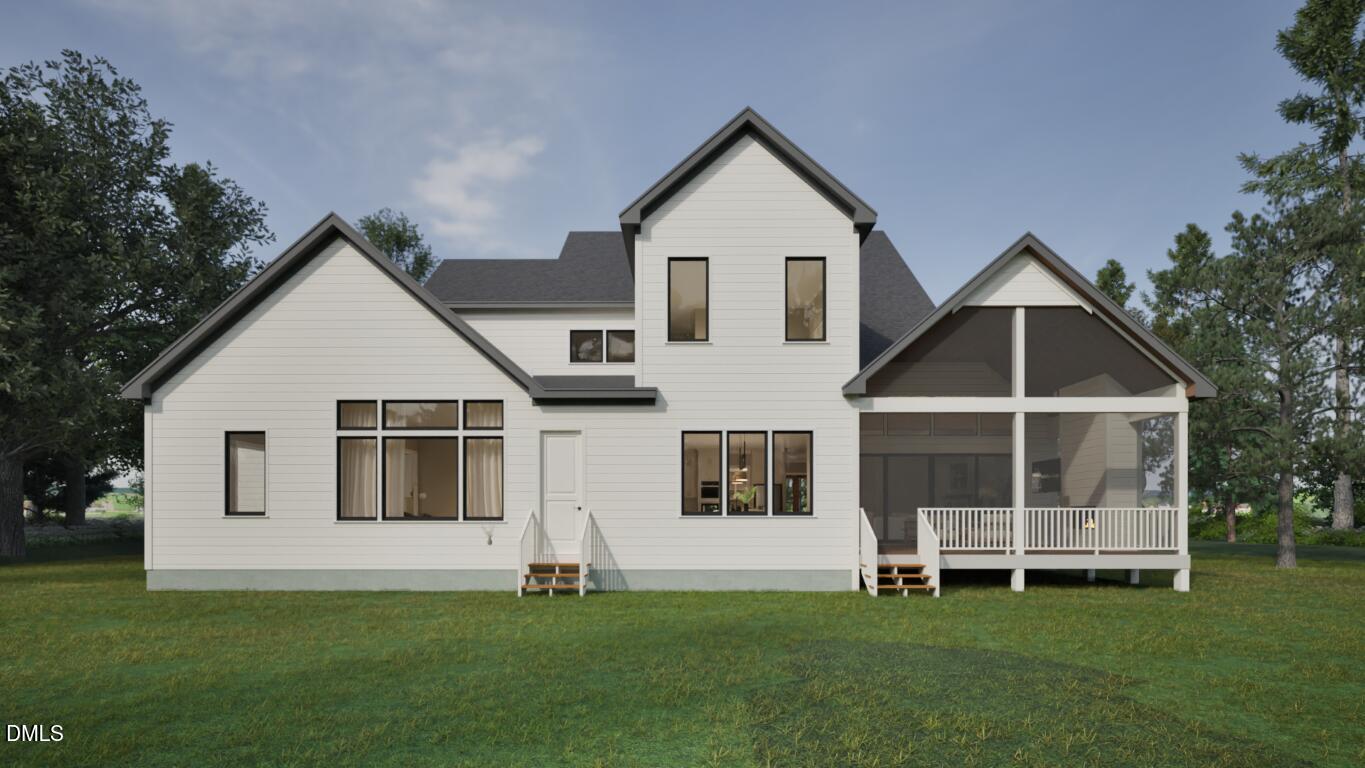 7429 Summer Tanager Trail Raleigh, NC 27614 - Photo 39 of 43 a front view of a white house with a yard and a garden