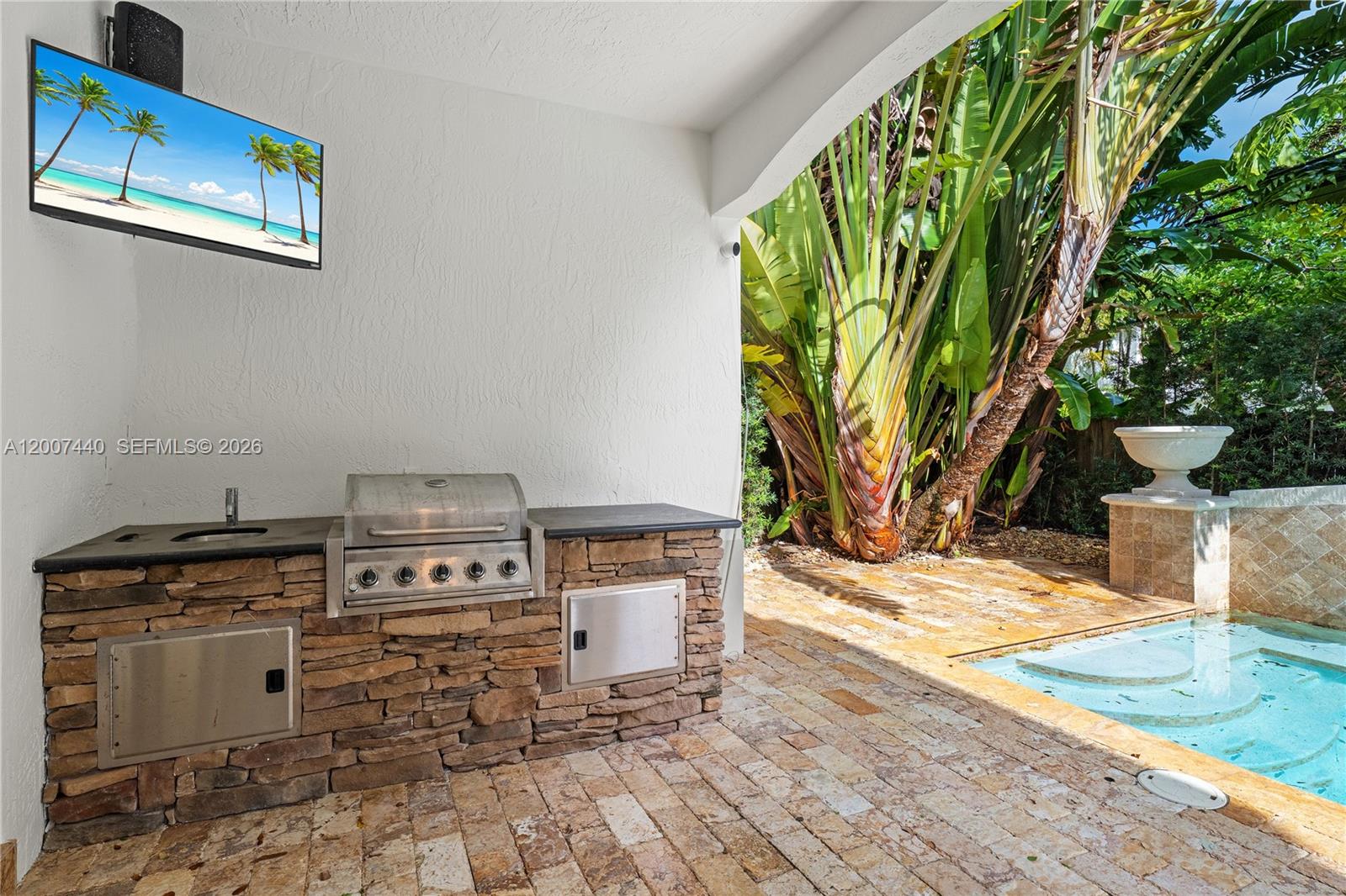 4065 Battersea Road Miami, FL 33133 - Photo 13 of 39 a view of a kitchen with furniture and a potted plant