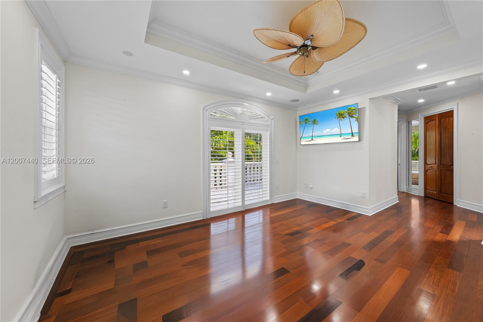4065 Battersea Road Miami, FL 33133 - Photo 16 of 39 a view of an empty room with a window and wooden floor