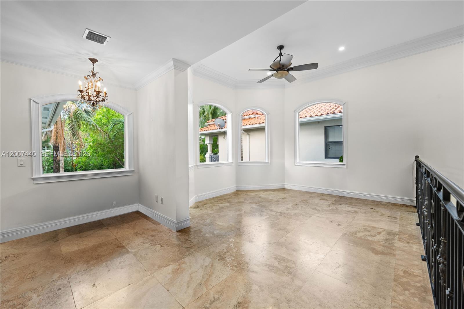 4065 Battersea Road Miami, FL 33133 - Photo 24 of 39 an empty room with windows and ceiling fan