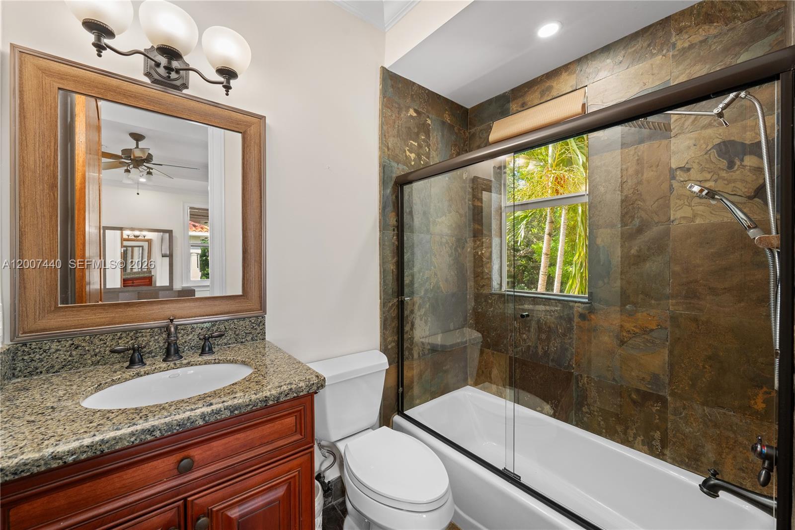 4065 Battersea Road Miami, FL 33133 - Photo 26 of 39 a bathroom with a granite countertop sink toilet and shower