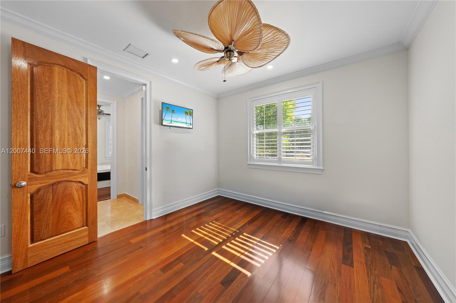 4065 Battersea Road Miami, FL 33133 - Photo 28 of 39 wooden floor in an empty room with a window