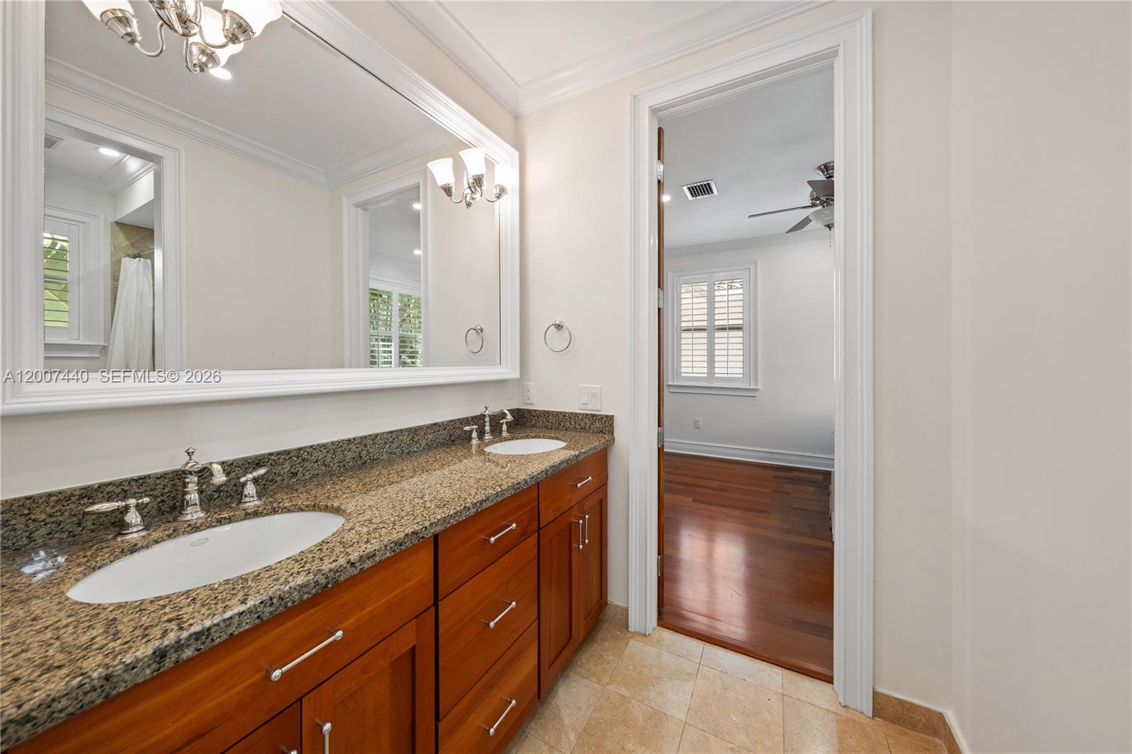 4065 Battersea Road Miami, FL 33133 - Photo 29 of 39 a bathroom with a granite countertop sink double and mirror