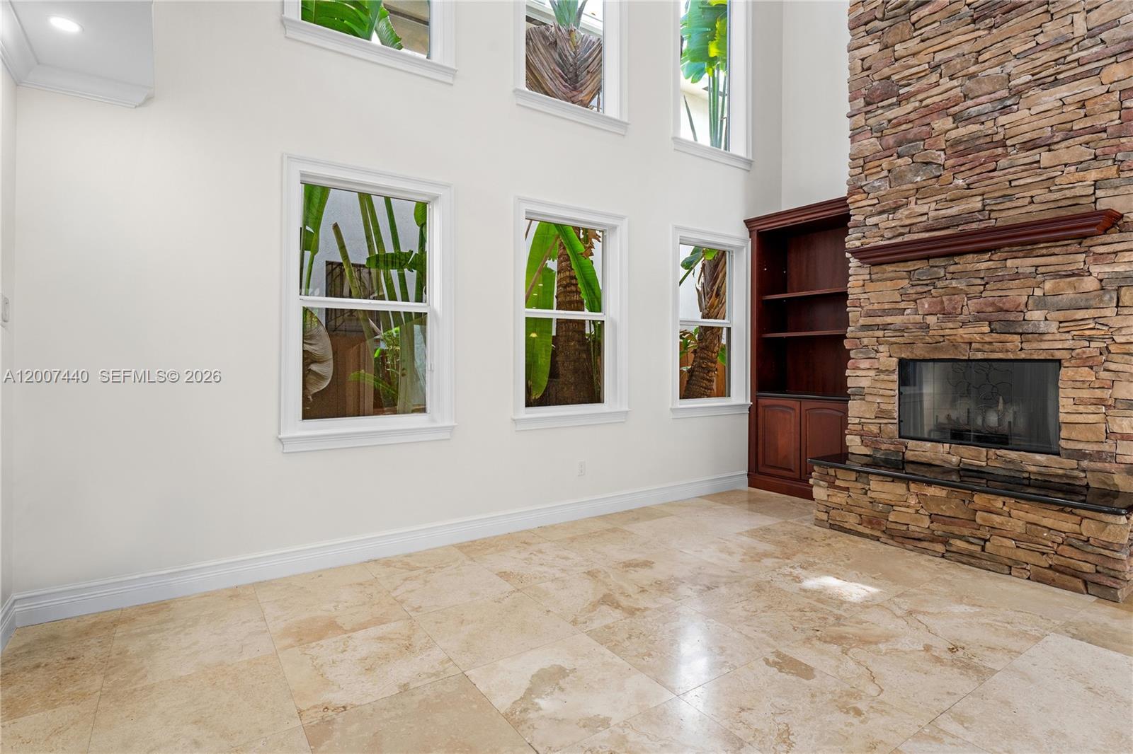 4065 Battersea Road Miami, FL 33133 - Photo 7 of 39 a view of an empty room with window and fire place