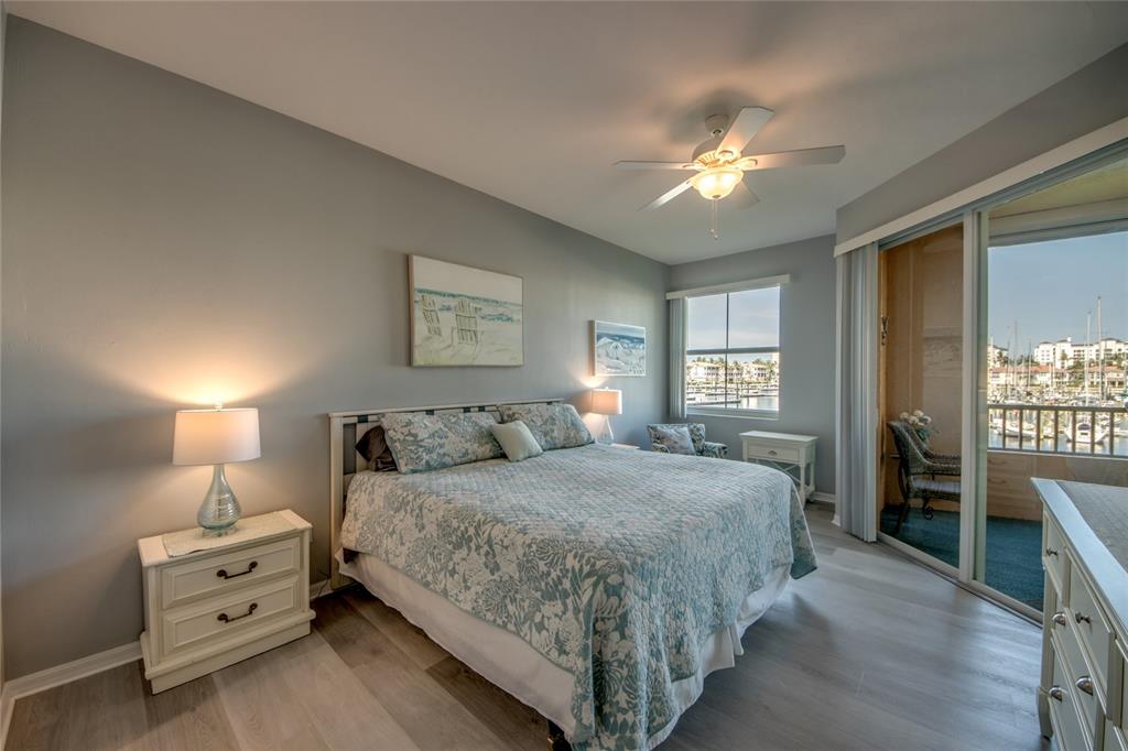 2090 Matecumbe Key Road, Unit 1202 Punta Gorda, FL 33955 - Photo 16 of 42 a bedroom with a bed and a chandelier