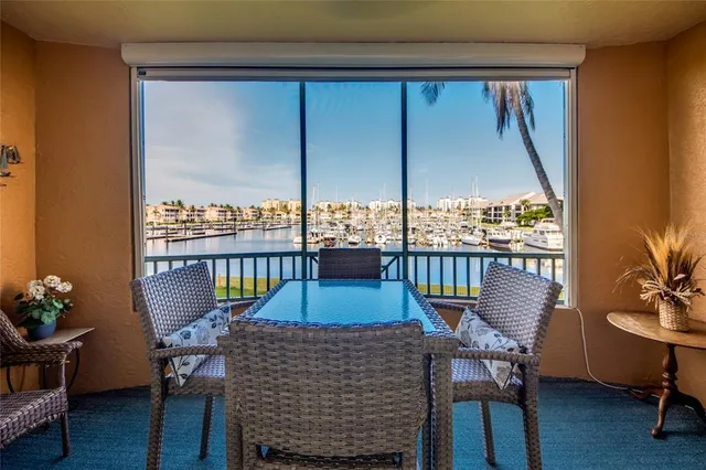a view of a balcony with chairs and a potted plant