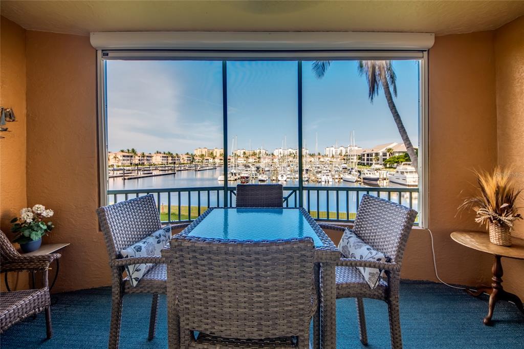 2090 Matecumbe Key Road, Unit 1202 Punta Gorda, FL 33955 - Photo 26 of 42 a view of a balcony with chairs and a potted plant