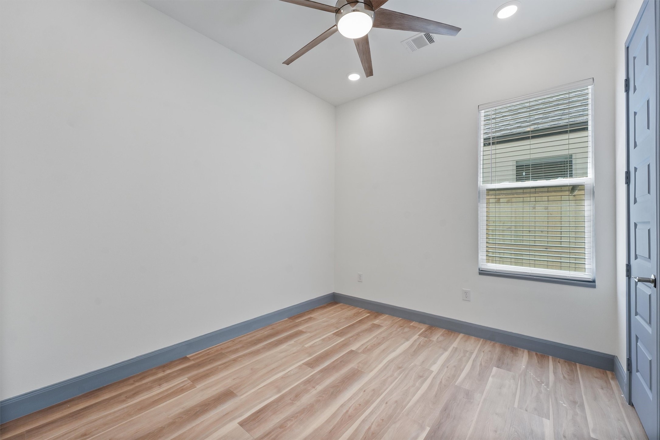 200 Canary Street Point Blank, TX 77364 - Photo 14 of 25 an empty room with a window and wooden floor