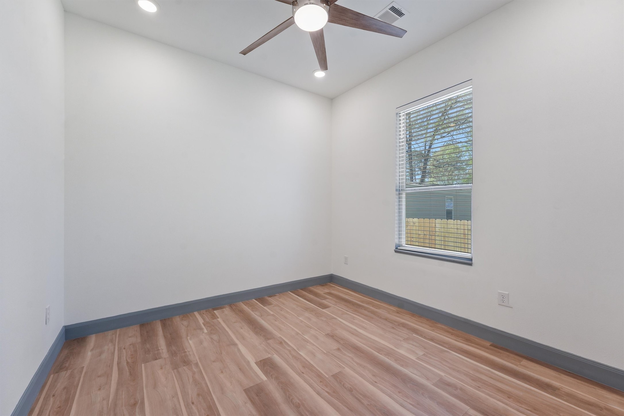 200 Canary Street Point Blank, TX 77364 - Photo 15 of 25 an empty room with a window and wooden floor
