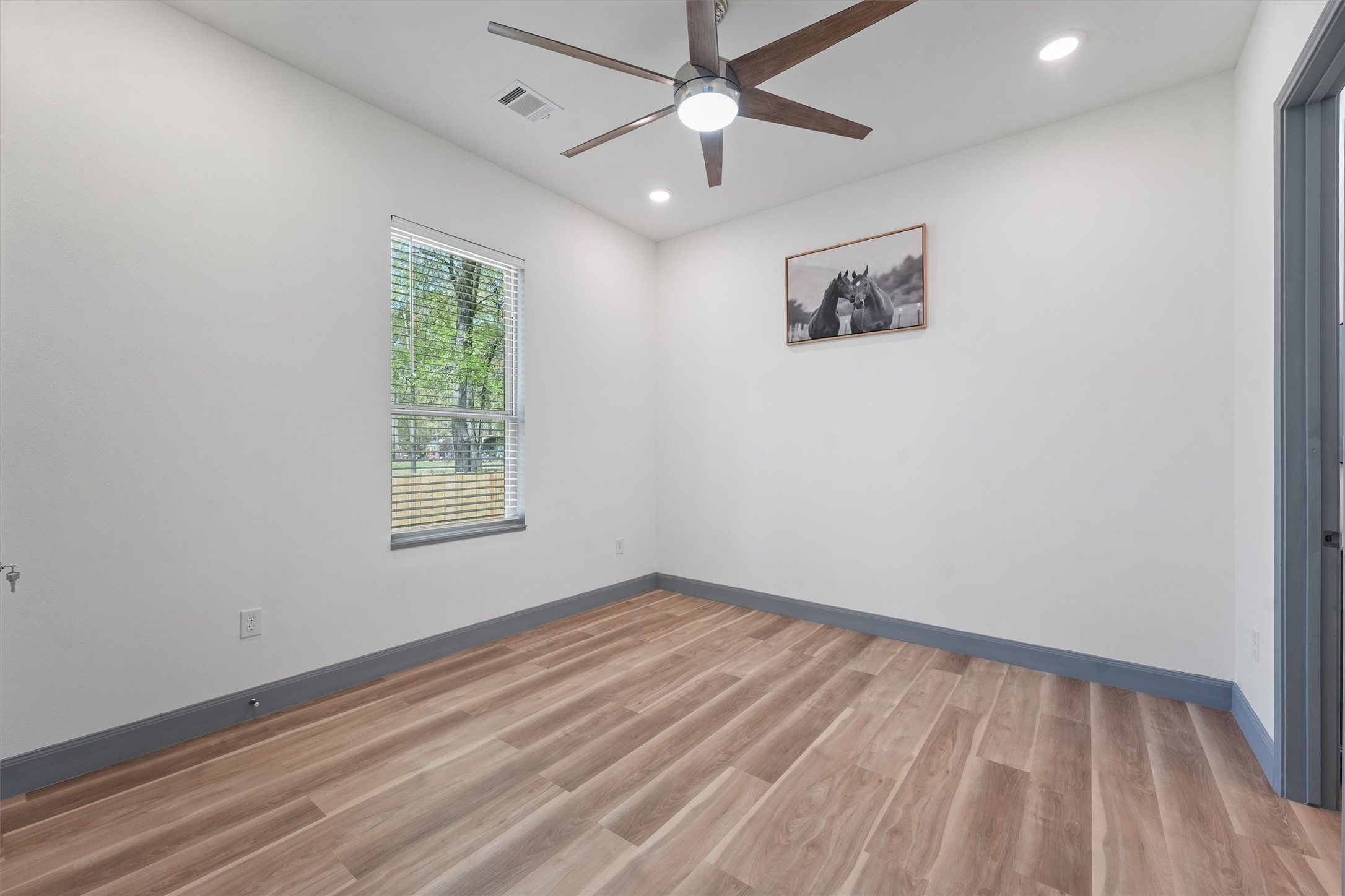 200 Canary Street Point Blank, TX 77364 - Photo 17 of 25 an empty room with a window and a ceiling fan